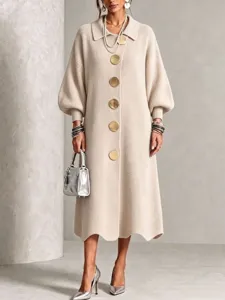 Detailed view of the elegant ribbed knit midi dress featuring large gold tone buttons.