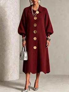 Detailed view of the burgundy knit dress featuring oversized metallic buttons and lantern sleeves.