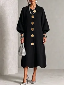Detailed closeup view of women's long sleeve knit dress featuring large gold buttons.