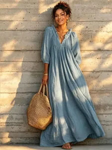 Detailed view of the bohemian style long sleeve maxi dress with v-neck and pleated ruffles.