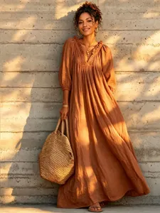 Bohemian resort style long V-neck lantern sleeve dress detail shot, perfect for summer vacation.