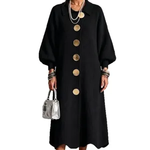 Women long black knitted maxi dress with statement metallic buttons and cozy winter style.