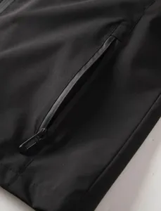 Close-up detail of mens windproof jacket showing durable waterproof zipper pocket design.