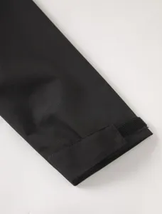 Close-up detail of mens windproof jacket sleeve cuff with adjustable velcro strap feature.