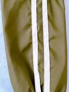 Close-up detail of men's casual sports jacket sleeve featuring classic dual side white stripes.