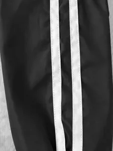 Black fabric jacket detail featuring two white stripes and clean stitching craftsmanship.