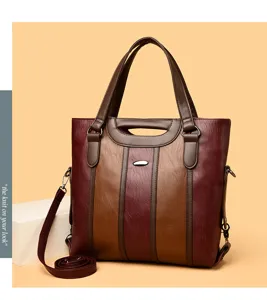 Detailed view of the color block leather handbag showing texture, handles and straps clearly.