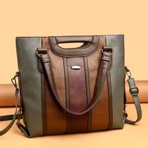Stylish color-block women's handbag with top handles and shoulder strap for daily use.