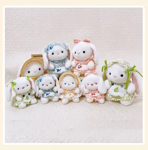 Detailed view of pastoral style long-eared plush rabbit toys set with floral dresses and cute hats.