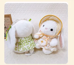 Detail view of pastoral style long-eared plush rabbit doll with floral dress and cute hat.