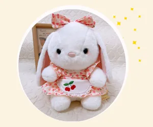 Detailed close-up of a cute plush rabbit toy wearing a sweet floral dress and cherry apron.