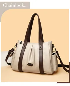Detailed view of women casual PU leather shoulder bag with contrast brown handle and logo accent.