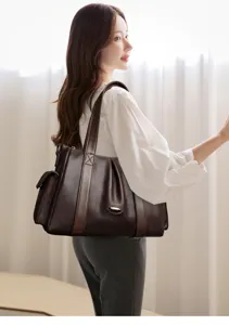 Dark brown leather tote bag detail view, stylish shoulder handbag for daily commuter use.
