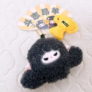 Cute black curly sheep plush keychain detail showing soft texture and mini trophy.