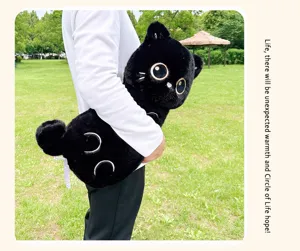 Detailed view of the black plush cat pillow showcasing soft fabric and cute eyes.