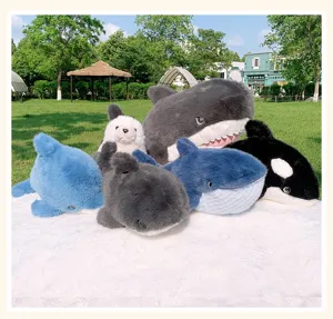 Detailed view of cute marine animal plush toys, soft shark and orca dolls for cozy room decor.