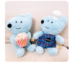 Cute blue plush dog toy details, soft stuffed puppy doll with popcorn and chef outfit close up.