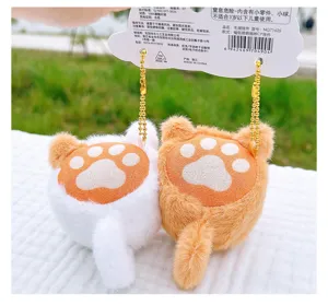 Cute magnetic cat butt plush bag charm pair with paw print and gold chain detail close up