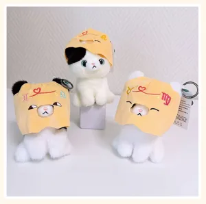 Cute plush keychain featuring yellow zodiac hood and soft fur, detailed close-up view.