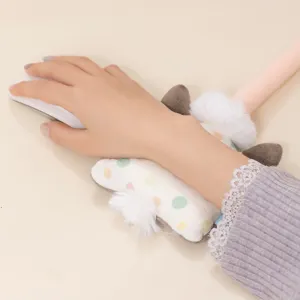 Cute plush animal wrist rest with colorful dots and fluffy ball for computer mouse support