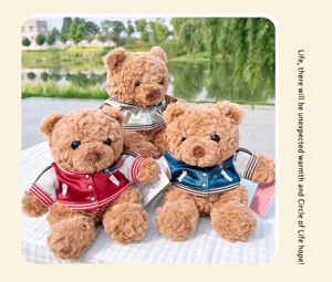 Close-up details of cute stuffed teddy bear plush toys wearing baseball jackets, soft texture.