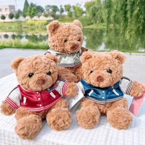 Cute plush teddy bear doll toy wearing varsity jacket, soft stuffed animal gift for kids.