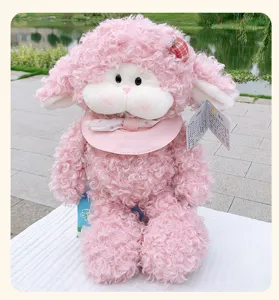 Detailed view of the cute pink curly sheep plush toy, featuring soft fur and sweet bib.