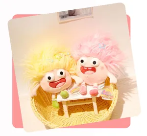 Close up detail view of funny plush doll toys featuring crazy hair and cute silly expressions.