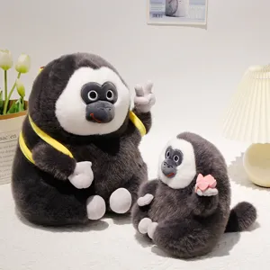 Simpatico peluche di scimmia saki dal faccia bianca con zaino a banana e bambola di loto