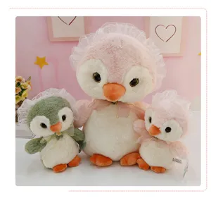 Close-up detail of cute lolita penguin plush toys set, soft stuffed animals in sweet room decor style.