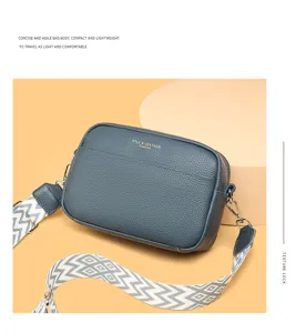 Genuine leather crossbody bag for women, stylish compact camera bag with wide strap.