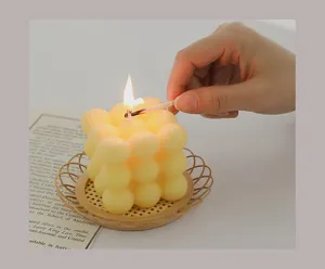 Handmade aesthetic bubble cube scented candle burning on a cute woven tray for cozy home decor.