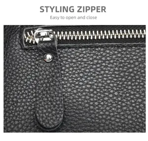 Detailed view of black genuine leather bag zipper and textured cowhide surface craftsmanship.
