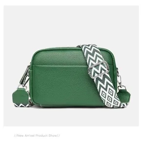 Green genuine leather camera bag for women, stylish crossbody bag with wide patterned strap.