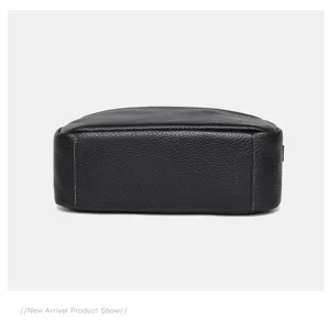 Detailed view of the black genuine leather square bag bottom, showing fine stitching and texture.
