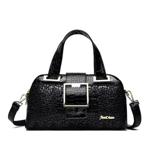 Borsa a mano nera in pelle verniciata con stampa coccodrillo e finiture dorate eleganti e pratiche.