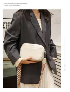 Detailed view of stylish genuine leather crossbody bag with wide strap, compact and chic.