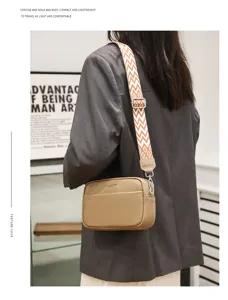 Detail view of genuine leather crossbody bag, minimalist small square bag with wide strap.