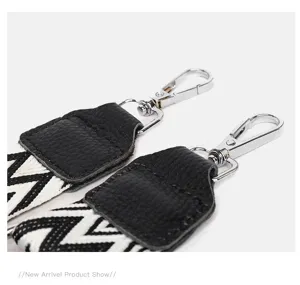 Replacement handbag strap with black white woven pattern and leather ends and metal clasps