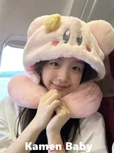 Pink plush Kirby character U-shaped travel neck pillow with cute hood detail in use.