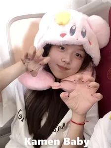 Cute cartoon pink plush travel neck pillow detail shot, soft U-shaped cushion for office flight.