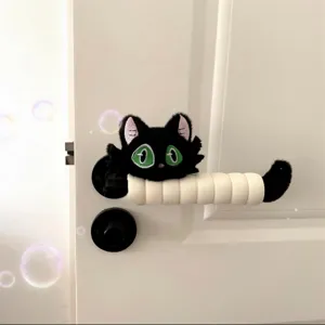 Cute black cat plush door handle cover with green eyes, anti-static protective decoration.
