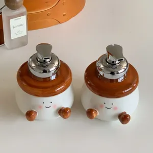 Cute ceramic soap dispenser detail, cartoon smile design with pump for bathroom decor.