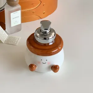 Cute chubby ceramic foaming soap dispenser with pump, funny face design for bathroom sink decor.