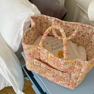 Detail shot of a pastoral floral quilted fabric storage basket, perfect for organizing items.