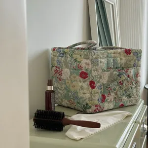Floral fabric storage basket detail view, portable organizer with compartments for home.