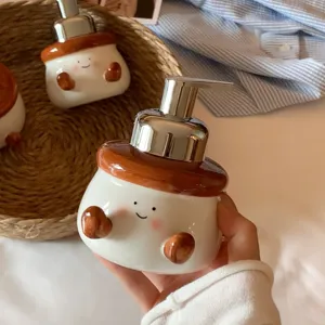 Cute ceramic foaming soap dispenser hand close-up, lovely cartoon face design for bathroom.