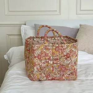 Korean pastoral floral quilted storage basket detail view, fabric organizer box with handles.