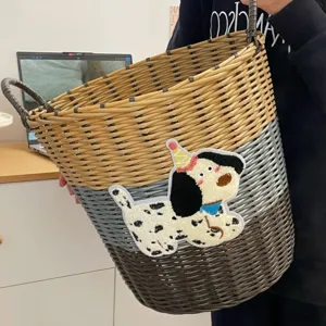 Imitation rattan laundry basket with cute dog embroidery and woven clothes storage bin.