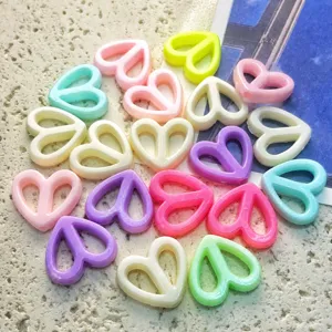 Close-up detail of colorful hollow heart beads, ideal for DIY handmade jewelry and crafting.